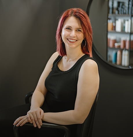 Anna sitting in a chair and posing for a photo