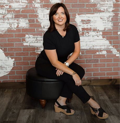 Jami sitting in a chair and posing for a photo