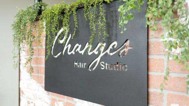 A sign of the Changes Hair Studio logo