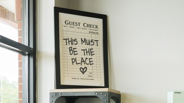 A framed quote in the salon that says, "This must be the place" with a heart