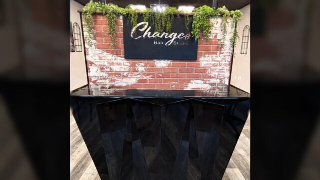 Salon_Counter Front counter of Changes Hair Studio. Black counter with brick wall backdrop.